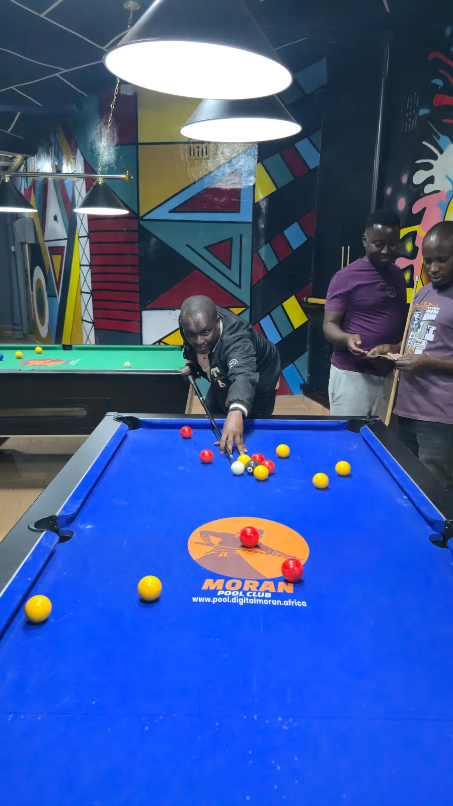 Hon. James Kuya Nina playing on a Moran Pool Club table